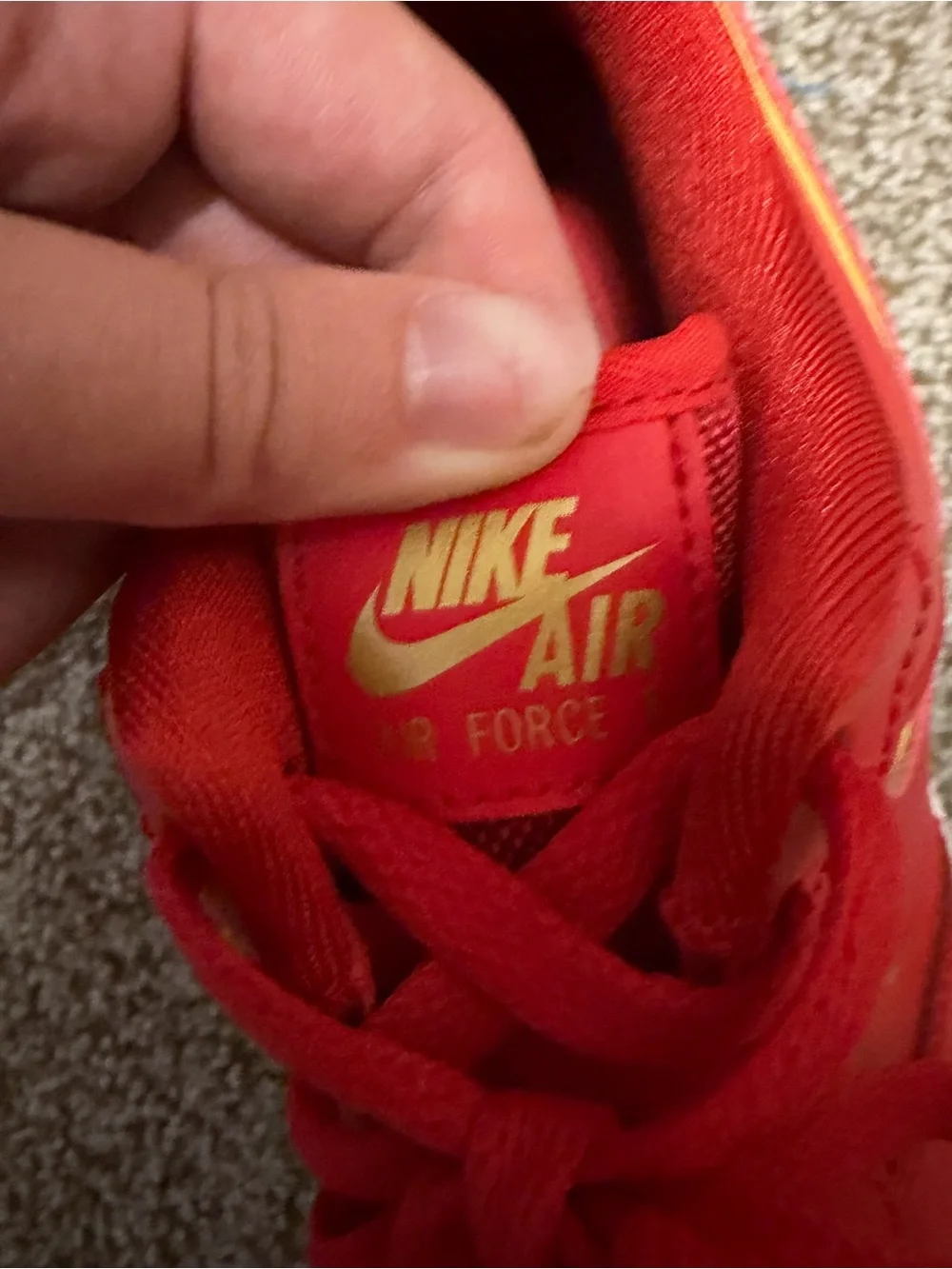 Nike Red Low-Top Sneakers with Gold Swoosh